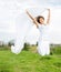 Young happy woman jumps and holding a white piece of cloth in th