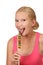 Young happy woman licking sweet lollipop