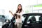 Young happy woman near the car with keys in hand - buying new car