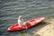 Young Happy Woman Paddling Kayak on Beautiful River or Lake at Sunset