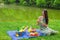 Young happy woman picnicking and relaxing outdoors