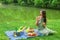 Young happy woman picnicking and relaxing outdoors