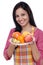 Young happy woman with plate of fruits