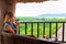 Young happy woman relaxing in lounge above tropical jungle