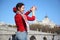 Young happy woman shows flamenco gesture near bridge