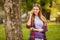 Young happy woman talking on cell phone in summer city park. Beautiful modern girl in sunglasses with a smartphone, outdoor