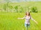 Young happy woman walking on wheat field