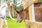 Young happy young girl feeding donkey on farm