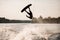 young healthy athletic guy makes incredible somersault on wakeboard