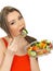 Young Healthy Attractive Woman Eating a Fresh Mixed Garden Salad