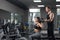 Young and healthy couple together in gym.