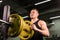 Young healthy man with big muscles holding disk weights in gym. Fitness, sport, training, motivation and lifestyle