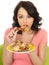 Young Healthy Woman Eating Cold Cooked Chicken Drumstick