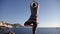 Young healthy woman practicing yoga on the beach at sunrise, benefits of natural environments for physical