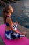 Young healthy woman practicing yoga near the sea