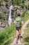 Young hiker with backpack on a mountain path, Lillaz waterfalls near Cogne, Gran Paradiso national park, Aosta Valley the Alps,