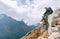 Young hiker backpacker female sitting on cliff edge and enjoying the Imja Khola valley during high altitude Everest Base Camp EBC