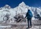 Young hiker backpacker female taking brake in hike walking enjoying Khumbu Glacier. Everest Base Camp route near Gorakshep,Nepal.