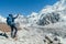 Young hiker backpacker female taking brake in hike walking enjoying Khumbu Glacier. High altitude Everest Base Camp route near