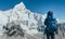 Young hiker backpacker female taking brake in hike walking enjoying Khumbu Glacier. High altitude Everest Base Camp route near