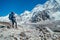 Young hiker backpacker female taking brake in hike walking enjoying Khumbu Glacier. High altitude Everest Base Camp route near