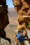 Young hiker climbs through rocks