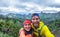 Young hiker couple taking selfie photo at peak of the mountain - Happy millennial people having fun in tour excursion - Travel,