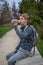 Young hiker with rucksack sitting on stone wall  drinking from waterbottle