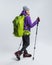 young hiker in sportswear with backpack and hiking sticks,