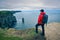 Young hiker standing at the cliffs of Moher