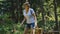 Young hiker using smart phone in the forest.