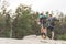 young hikers with backpacks standing on cliff