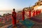 Young hindu monks conduct a ceremony to meet the dawn on the banks of the Ganges, and raise the Indian flag.
