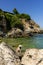 Young hippie beautiful nudist woman on the sea shore in summer time having relaxing time in water on o sunny day