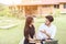 Young hipster couple enjoying a good read together while relaxing outdoors