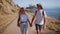 Young hipster couple hikes on mountain road on sunset