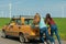 Young hipster friends on road trip on a car