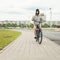 Young hipster girl with black bike