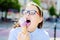 Young hipster girl eating a delicious ice cream in summer have f