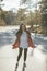 Young hipster girl is standing on the middle of road at the forest. Awesome atmosphere, spring, lovely day