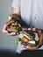 Young hipster holding vegetarian carrot tofu burgers