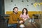 Young hipster male and female working laptop together in cafe