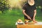 Young hipster man preparing food for garden grill party, summer barbecue