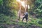 Young hipster man puts bag whit shoes footwear walking to climbing mountains travel forest nature background, Local thailand