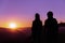 Young hipster photographer holding the camera with sunset on mountain natural background