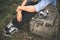 Young hipster traveller woman with backpack sitting in the grass