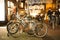 young hipsters cyclists ride past bicycle parking in a European city late at night.