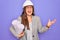 Young hispanic architect woman wearing builder hat and holding blueprints over yellow background very happy and excited, winner