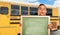 Young Hispanic Boy with Blank Chalkboard Near School Bus