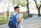 Young Hispanic boy with packpack walk on college campus